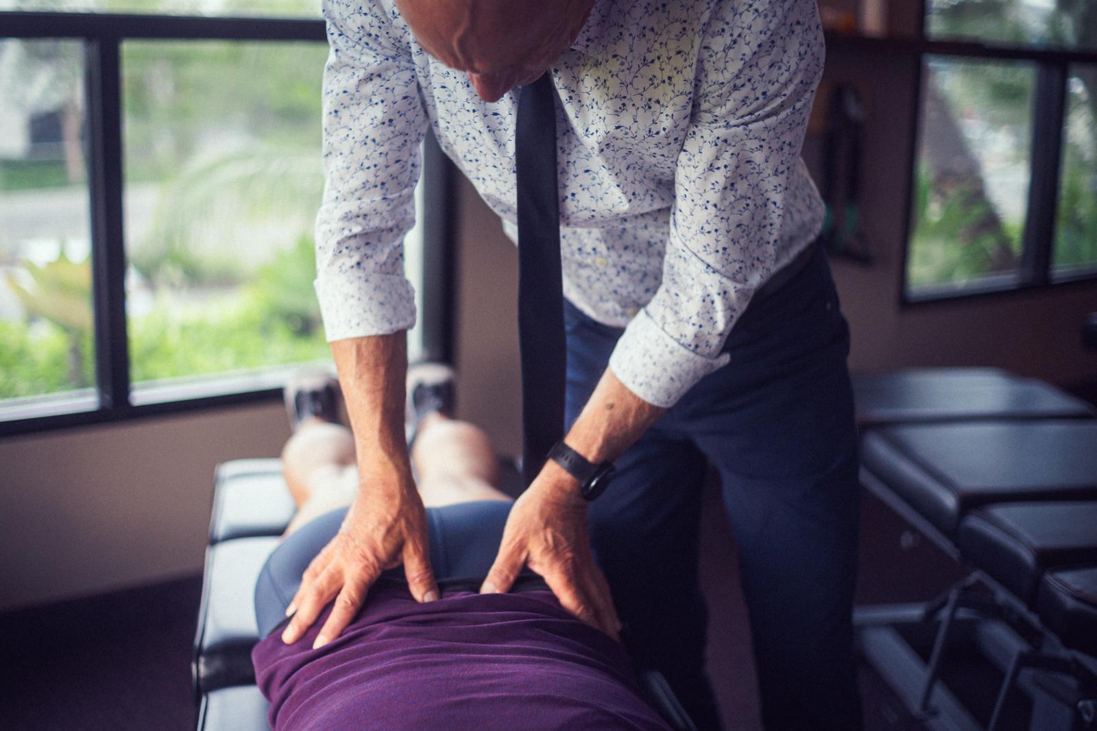 Dr. Billy DeMoss adjusting a patient’s back