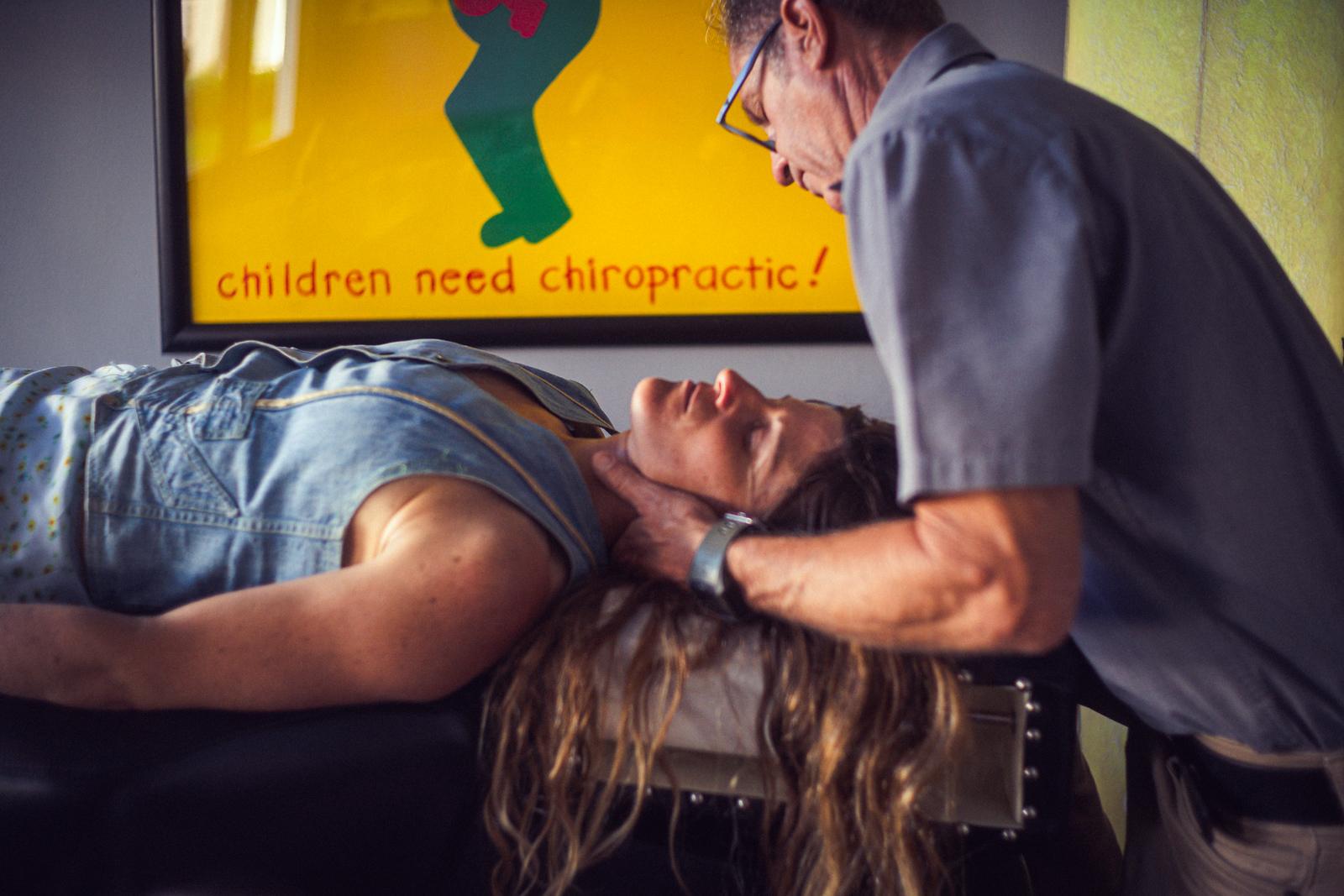 Dr. Joe DeMoss adjusting a patient’s upper neck