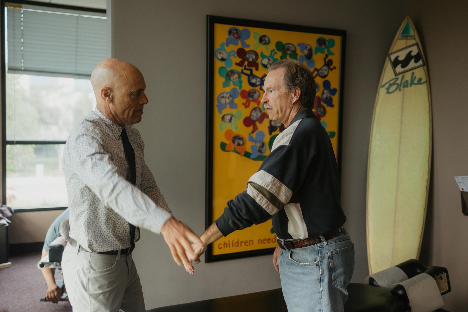 Dr. Billy DeMoss assessing a patient at DeMoss Chiropractic, Newport Beach
